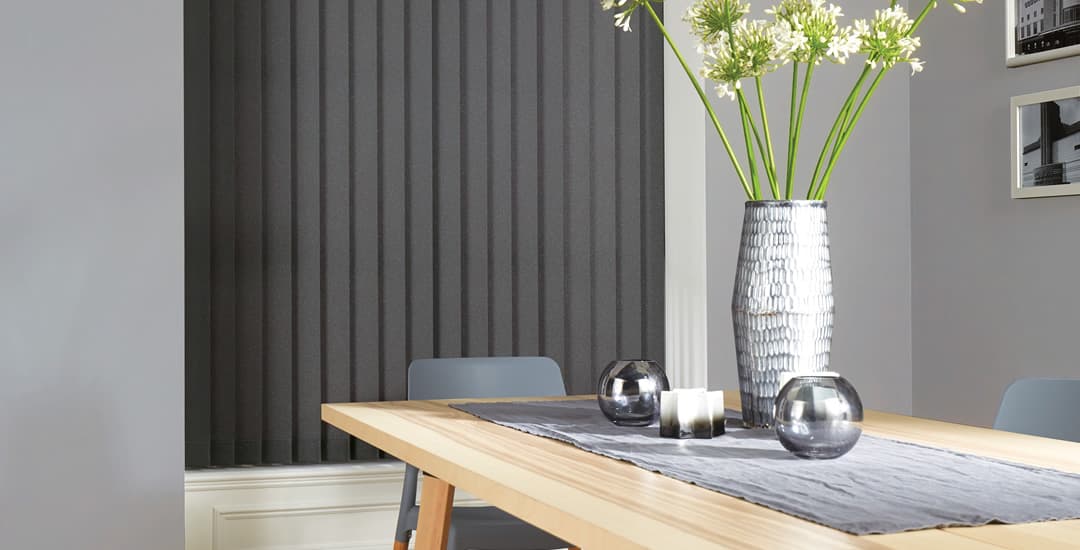 Grey vertical blinds in dining room