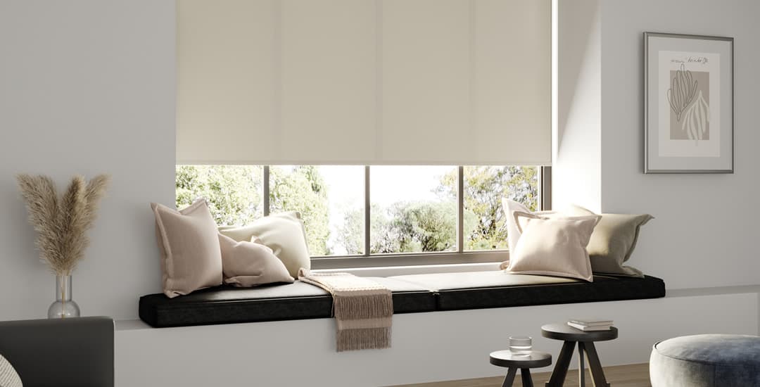 Luxury cream textured roller blinds above window seat