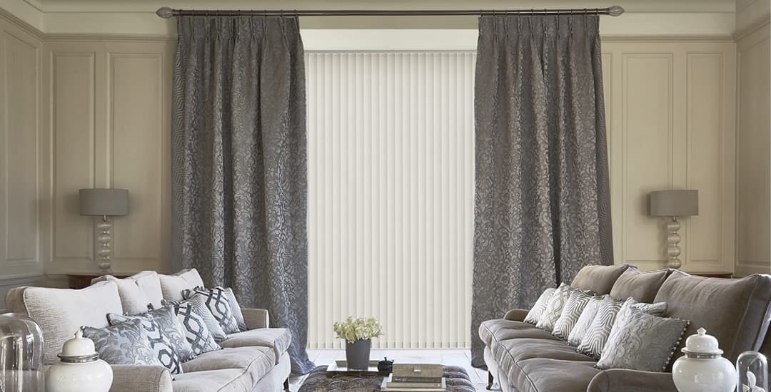 Luxury grey curtains with off white vertical blinds in lounge