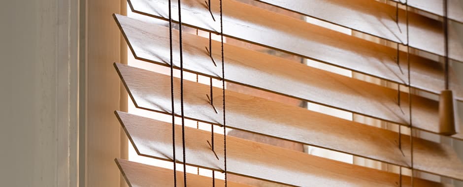 Side on view of wooden blinds showing thickness of slats