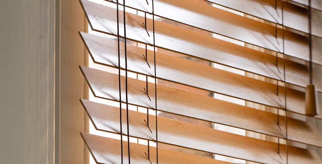 Side on view of wooden blinds showing thickness of slats