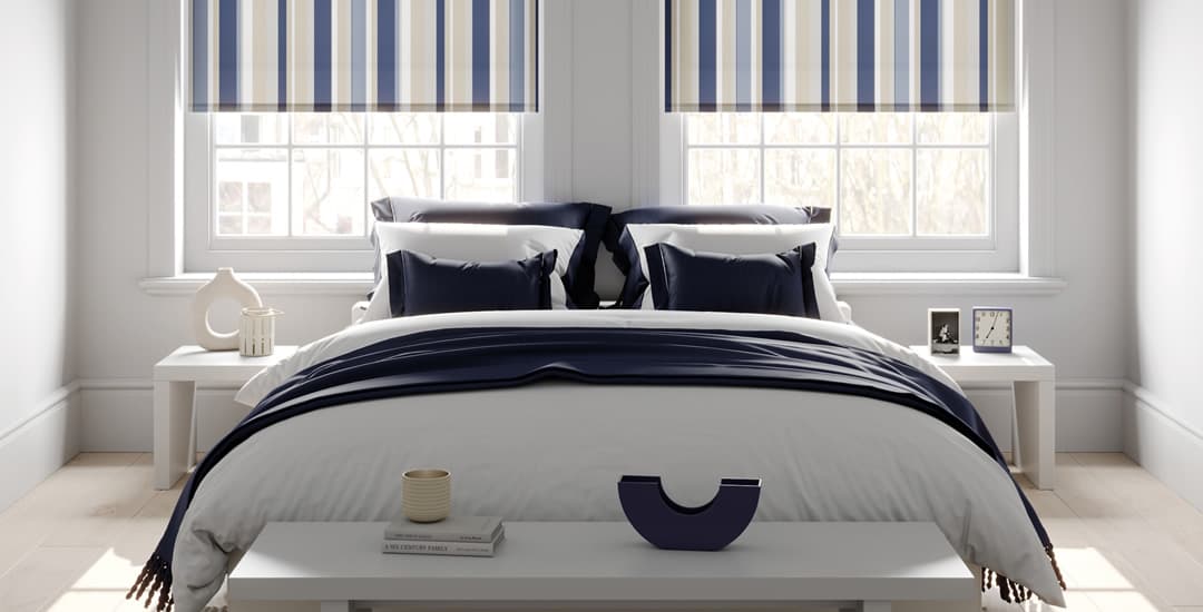 Blue and white themed bedroom with striped roller blinds