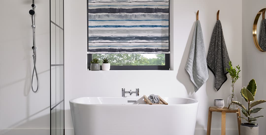 Blue striped roller blinds in white bathroom