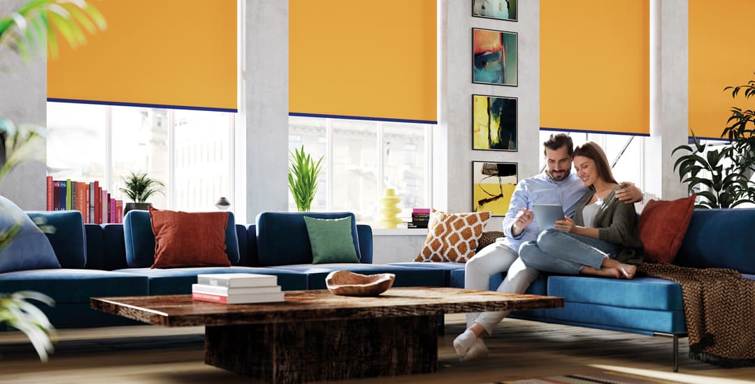 Colourful contemporary living space with yellow roller blinds