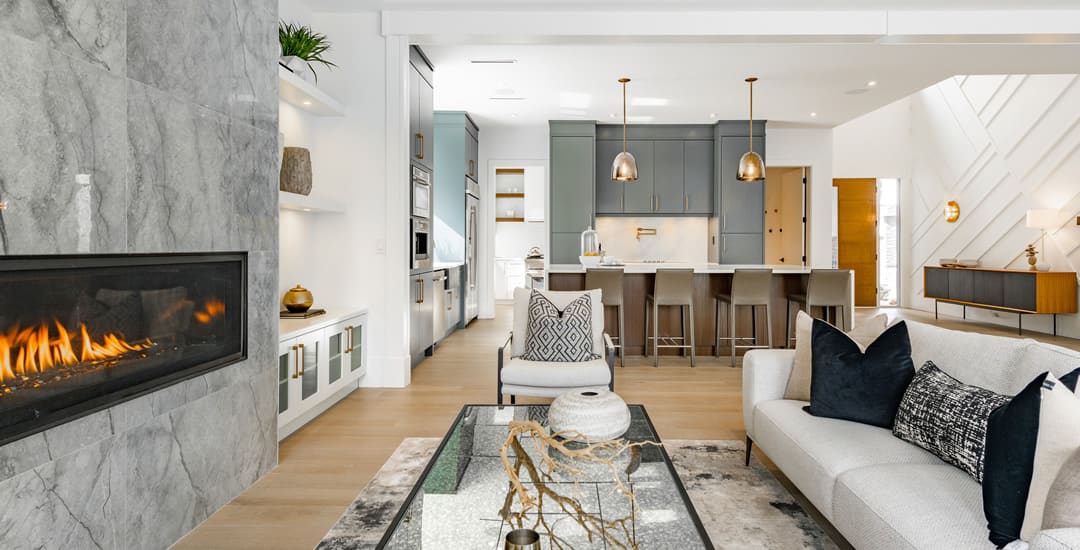 Contemporary open plan living room kitchen with marble fireplace