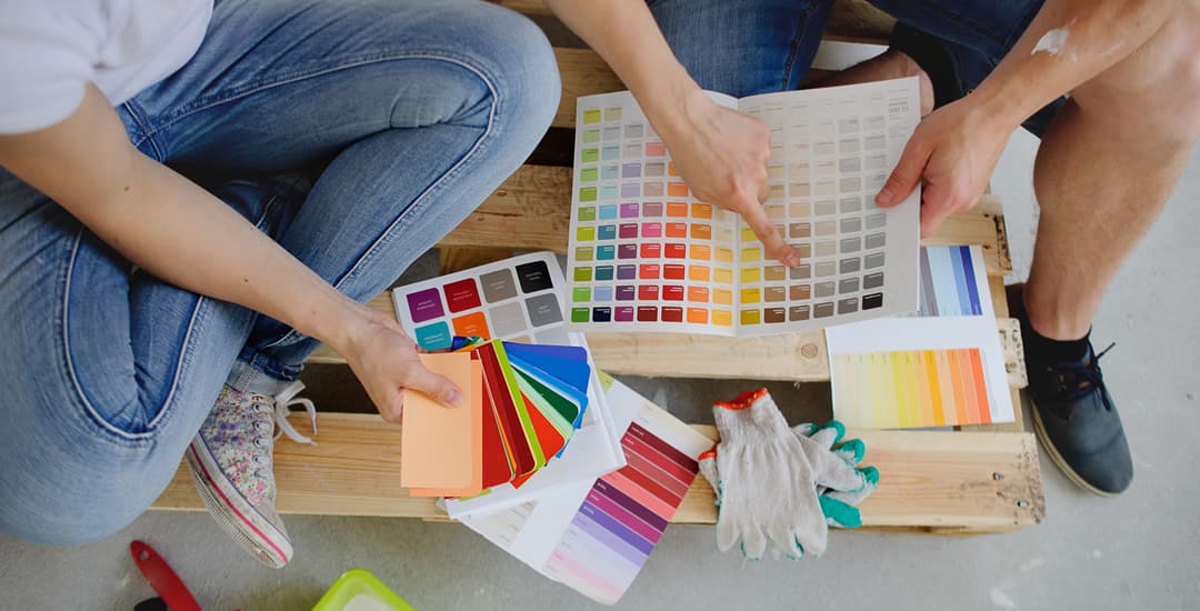 Couple choosing paint colours for decorating
