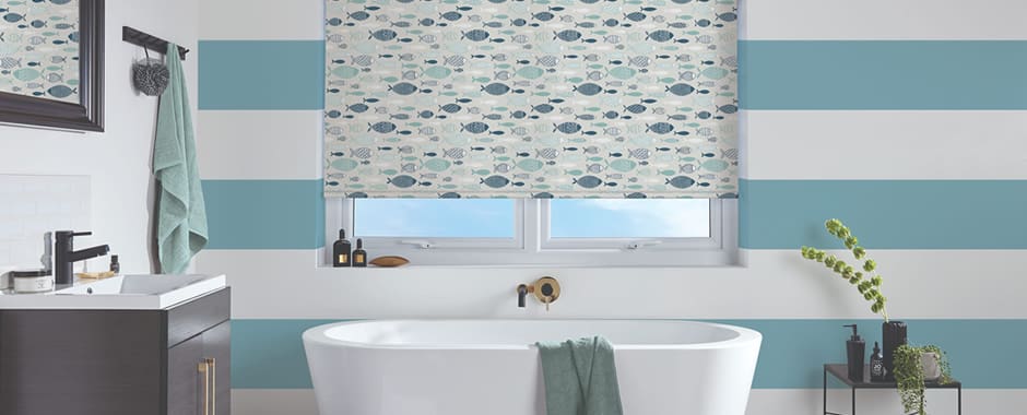 Fish patterned roller blinds in blue and white striped bathroom
