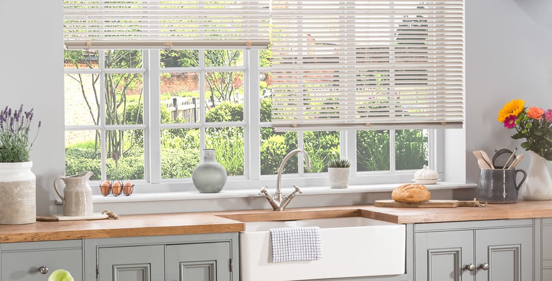 Cream aluminium venetian blinds in kitchen window