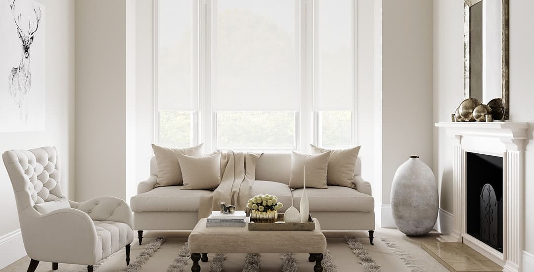 Pure white roller blinds in living room bay window