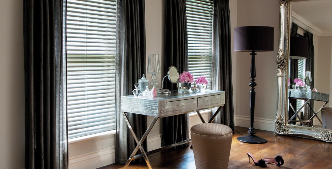 Dark faux wooden blinds in glamorous bedroom
