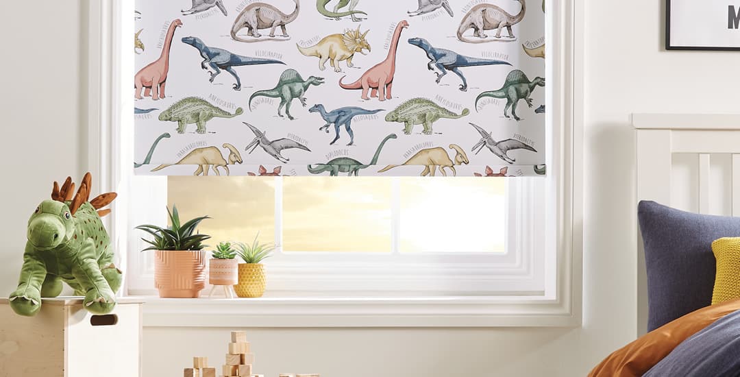 Dinosaurs patterned blackout roller blinds in kids’ bedroom close up