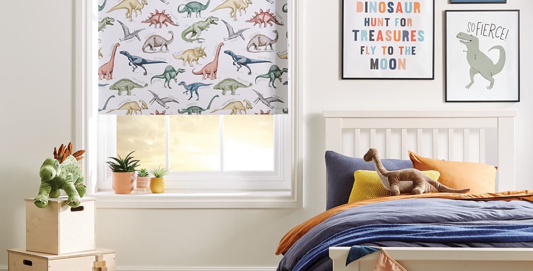 Dinosaurs patterned blackout roller blinds in kids’ bedroom