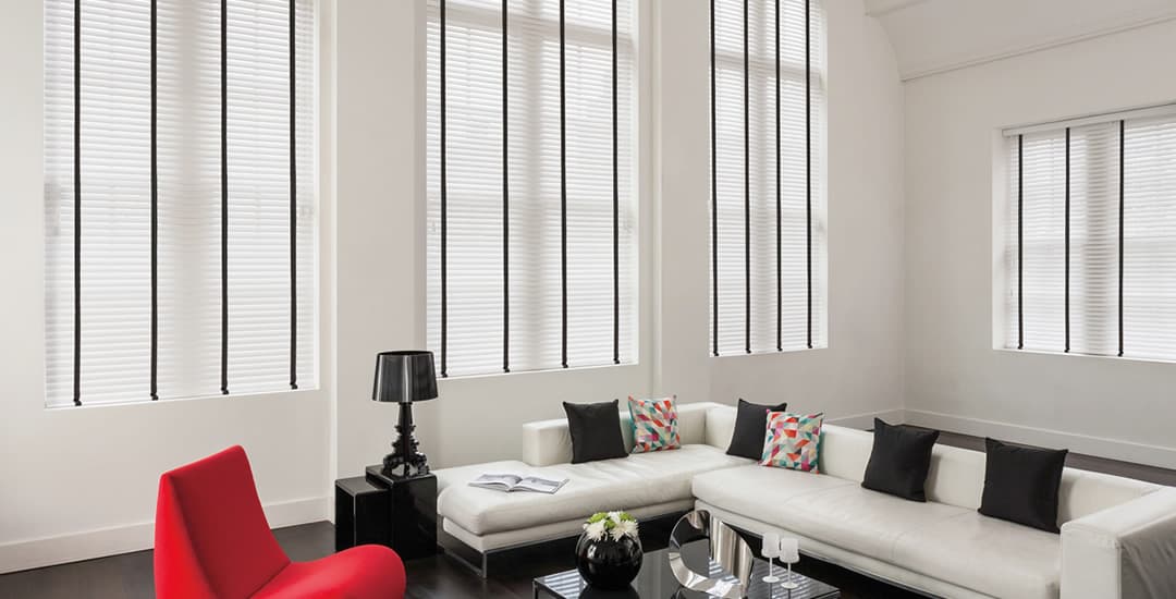 Large white faux wood blinds black tapes in living room