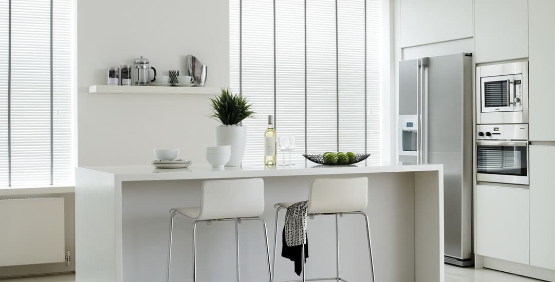 Long white faux wood blinds with grey tapes in modern kitchen