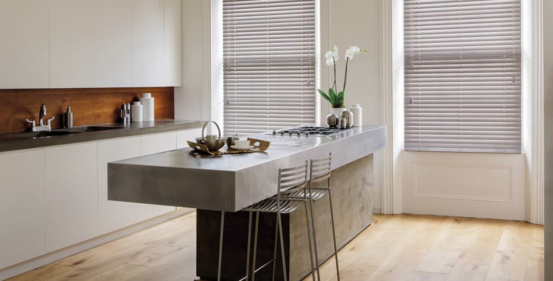 Modern kitchen with wood flooring and blinds