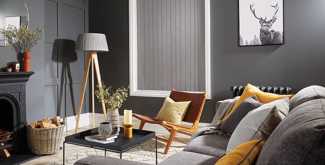 Silver grey vertical blinds in yellow and grey themed siting room