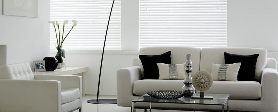 White faux wood blinds in living room
