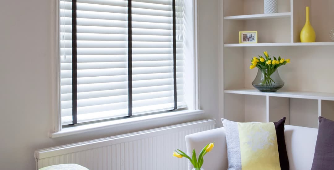 White faux wooden blinds black tapes living room