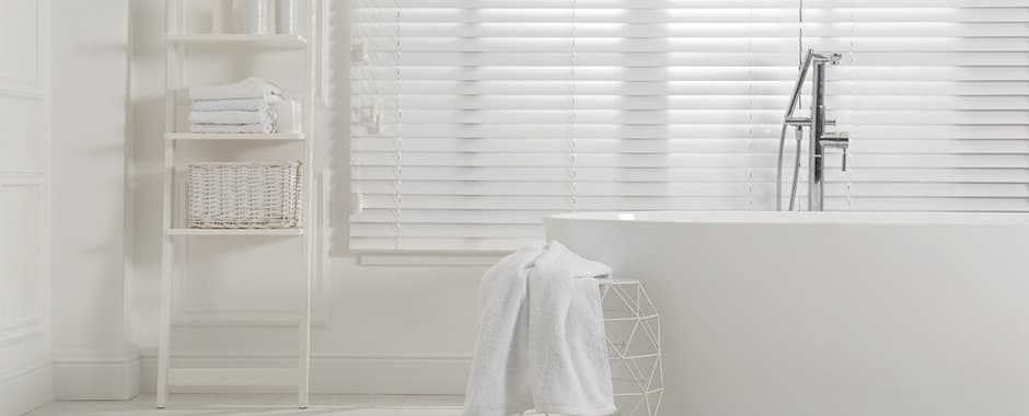 White faux wood blinds in cosy modern bathroom