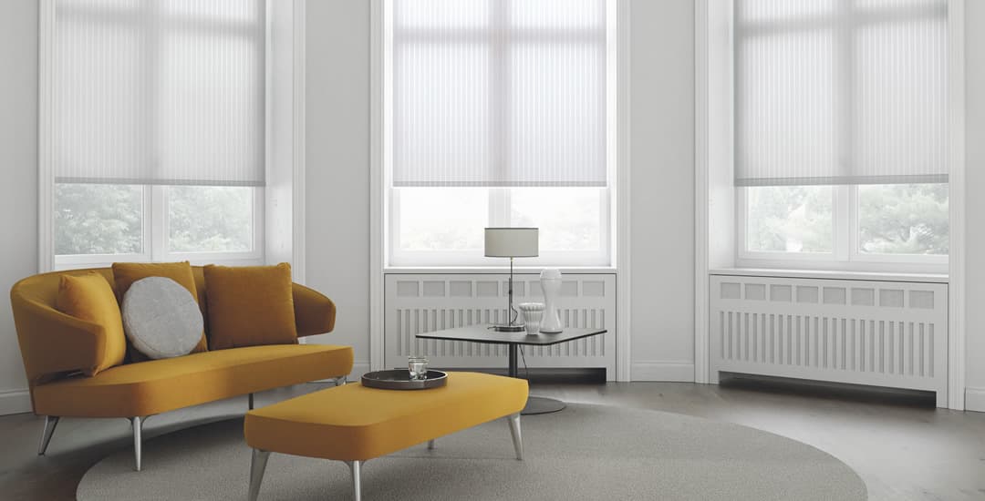 White striped roller blinds in lounge with yellow sofa