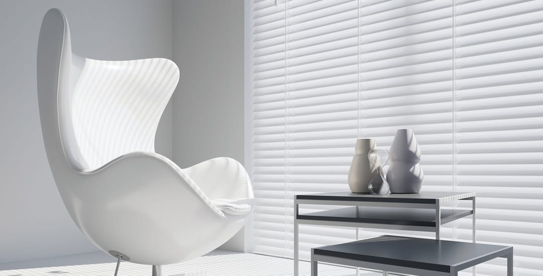 White wooden blinds in large window