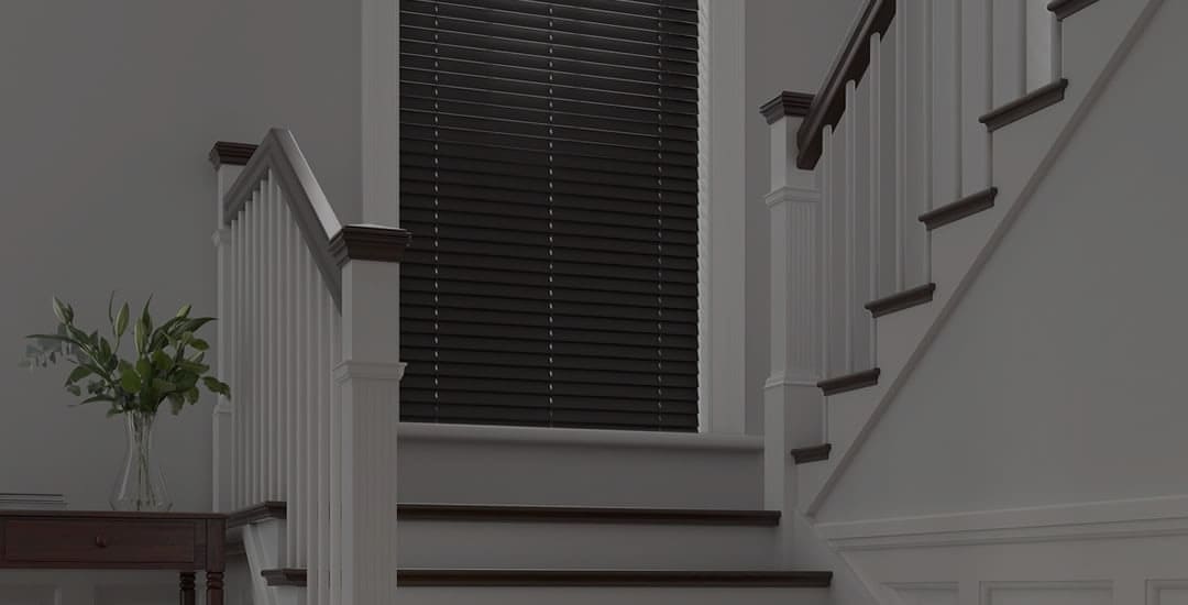 Closed dark wooden blinds on staircase