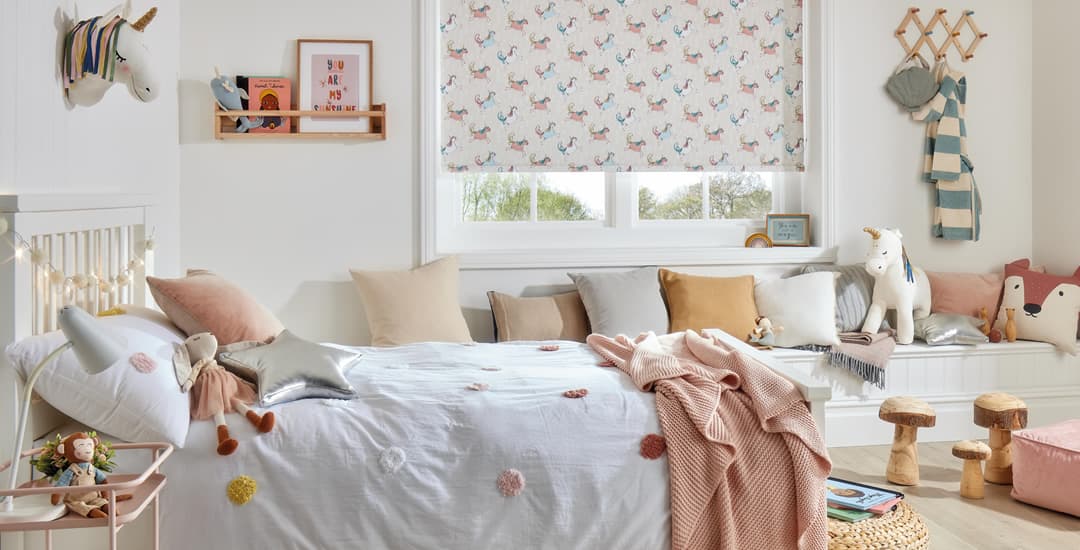 Unicorn patterned blackout roller blinds in children’s bedroom