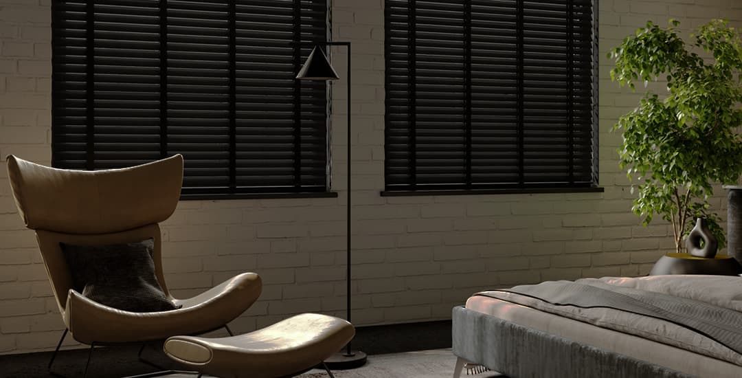 Black wood venetian blinds in bedroom at night