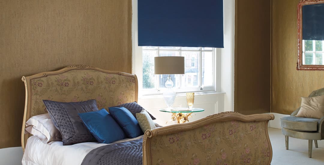 Blue blackout roller blinds in luxury bedroom