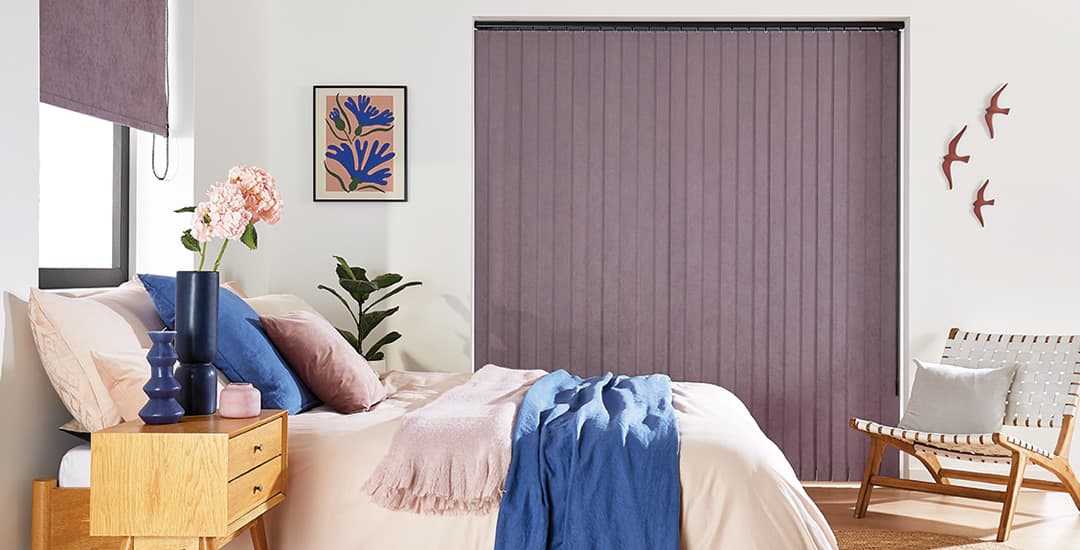 Purple suede vertical blind and roller blind in bedroom