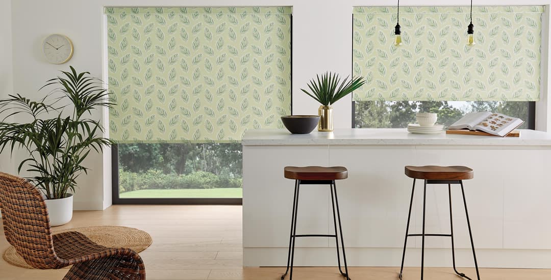Green fern patterned roller blinds in kitchen