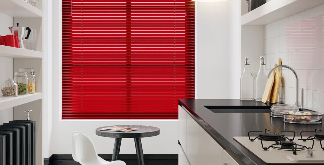 Red Venetian blinds in modern kitchen
