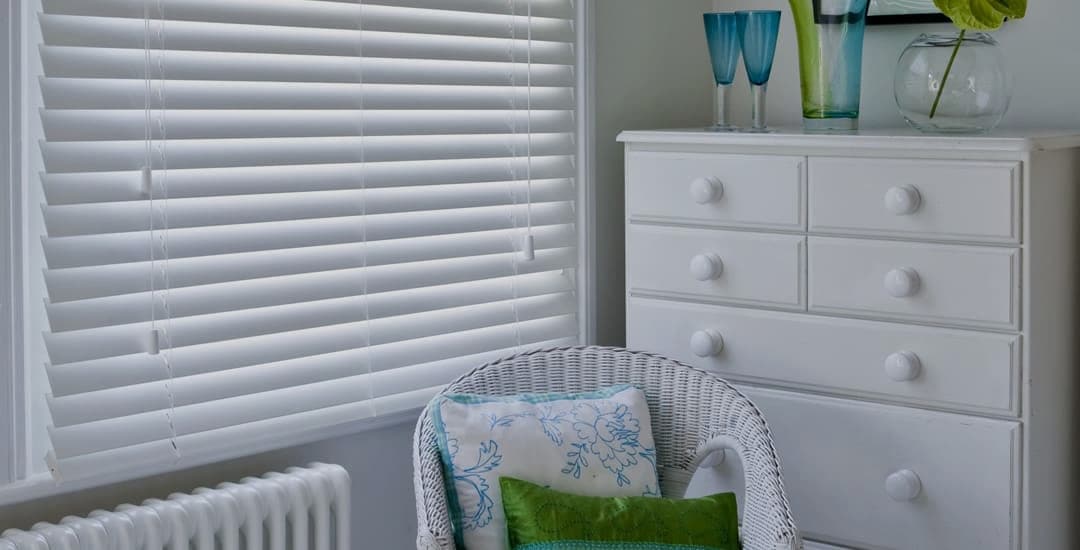 Closed 50mm white faux wood blinds in sitting room