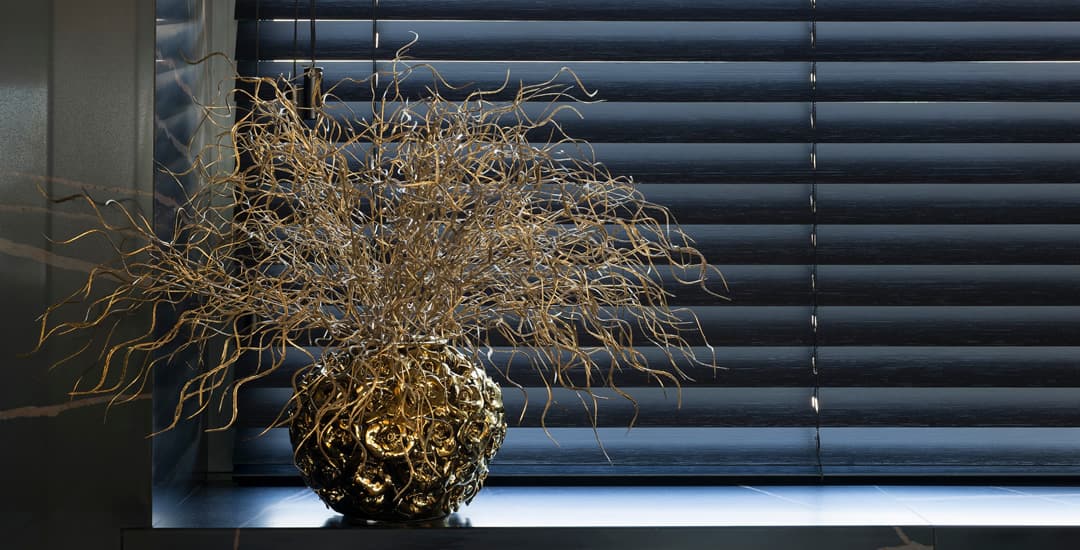 Closed dark faux wood blinds in the kitchen window