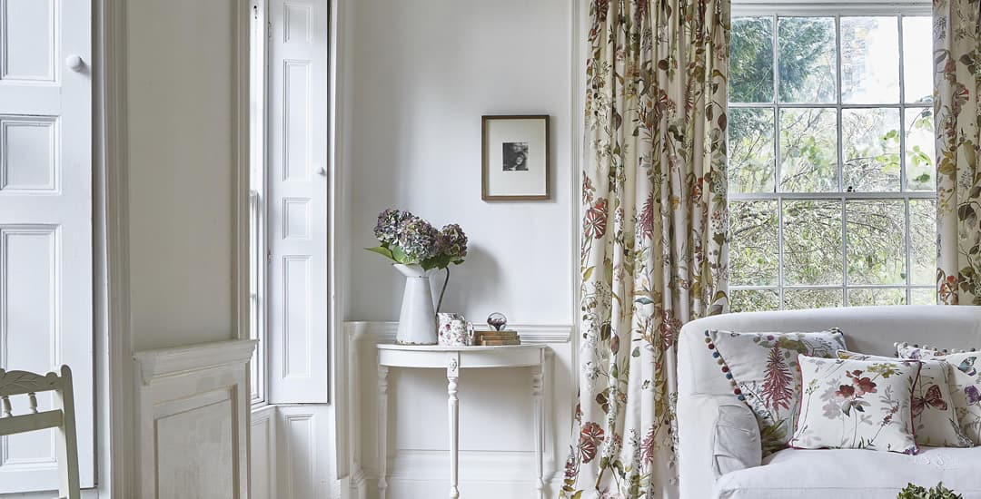 Luxury cream floral curtains in a white panelled sitting room