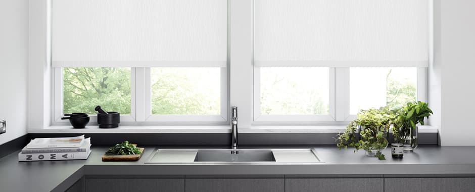 White PVC roller blinds above a kitchen sink