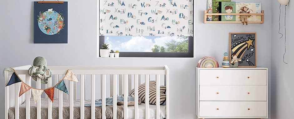 ABC animal patterned blackout roller blinds in a nursery