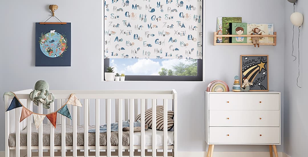 ABC animal patterned blackout roller blinds in a nursery
