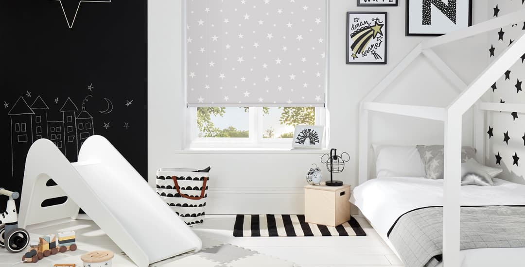 Glow in the dark stars patterned blackout roller blinds in black and white nursery