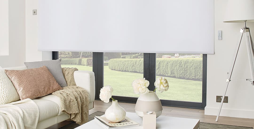 Large white blackout roller blind over a lounge patio window