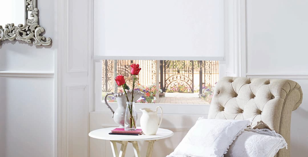 White blackout roller blinds in a traditional sitting room