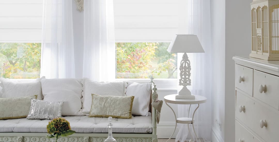 White blackout roman blinds in a vintage-styled living room