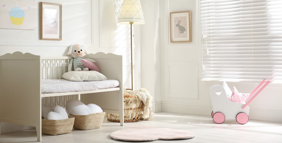White faux wood blinds in children’s nursery