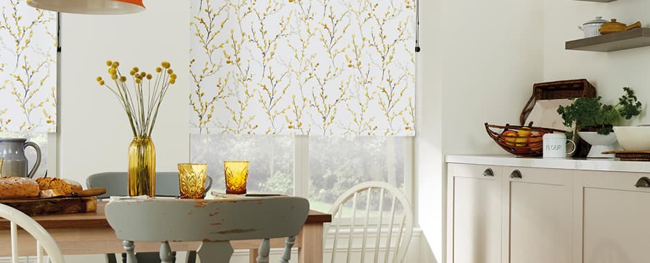 Yellow and white willow patterned roller blinds in a country kitchen