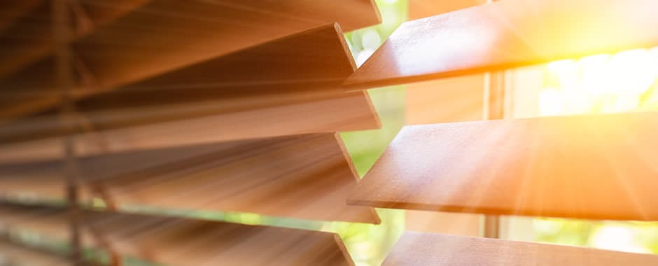 Closeup of wooden Venetian blinds in direct sunlight