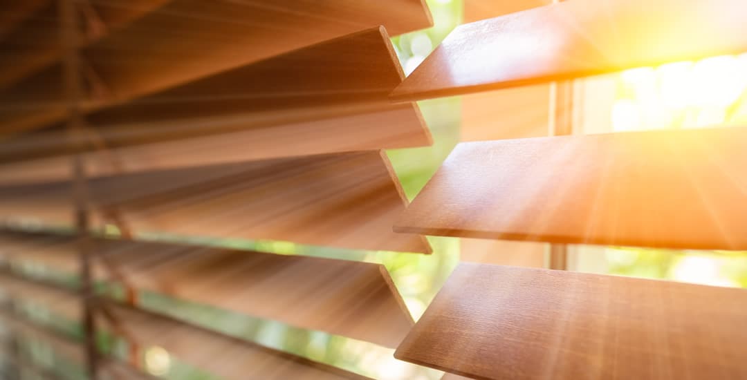 Closeup of wooden Venetian blinds in direct sunlight