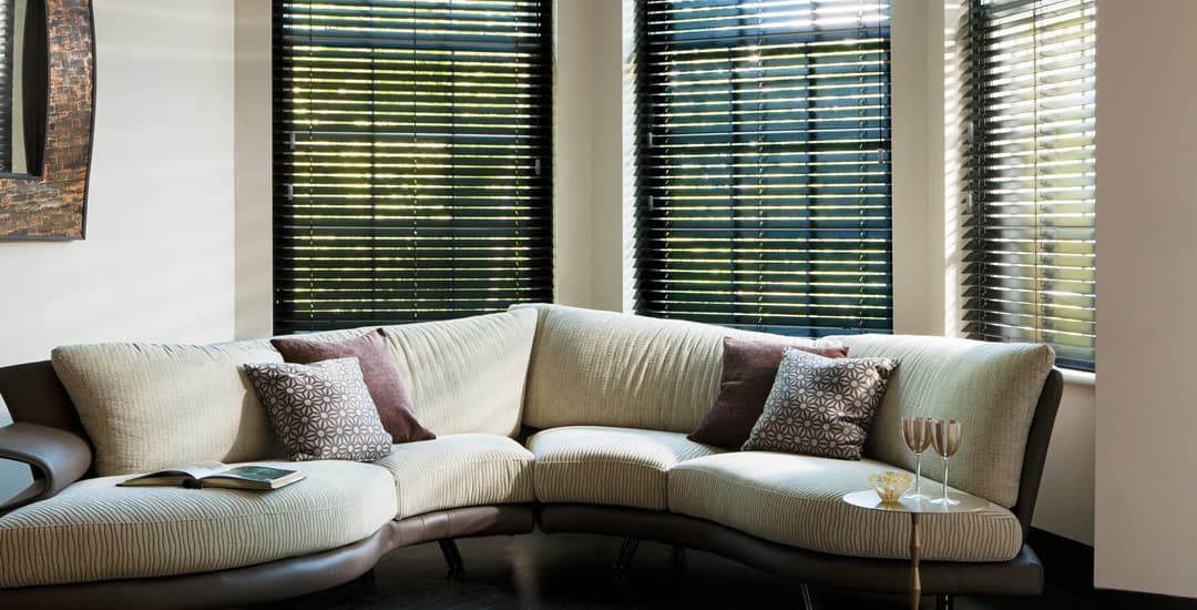 Dark wooden blinds in sumptuous living room 