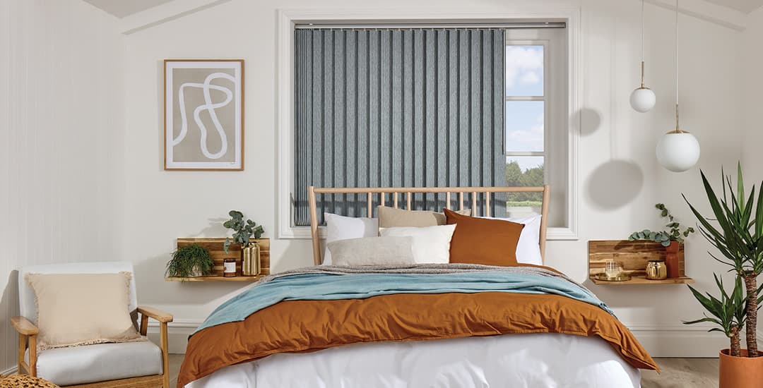 Luxury grey blackout vertical blinds in cosy bedroom
