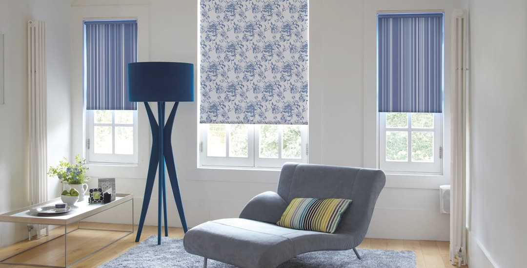 Mixed striped roller blinds and floral patterned roller blinds in the same living room