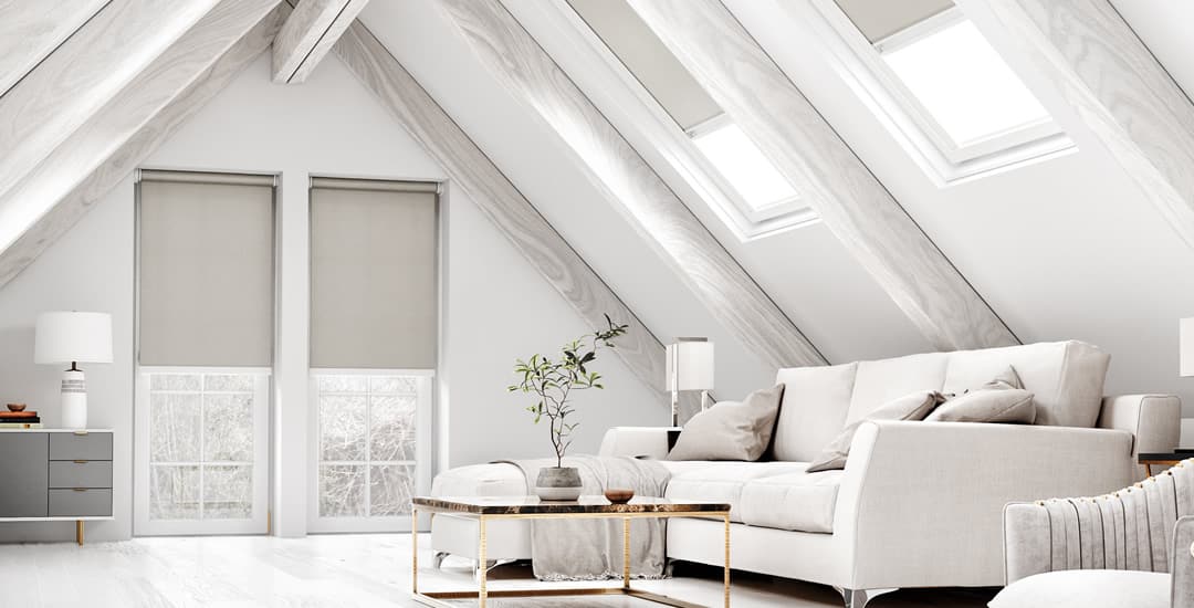 Pale taupe blackout roller blinds and Velux blinds in luxury converted attic